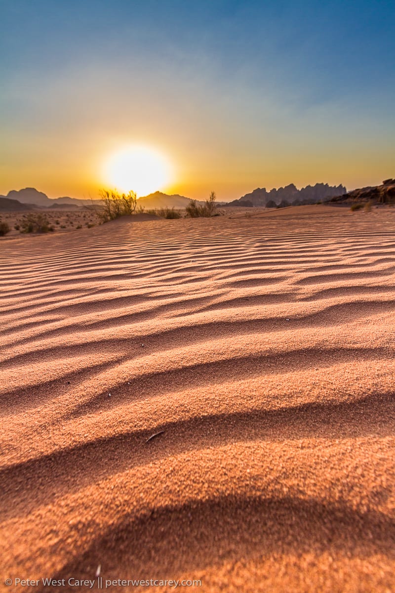 View of sunset with rippled sand in foreground – Jordan – Wadi Rum