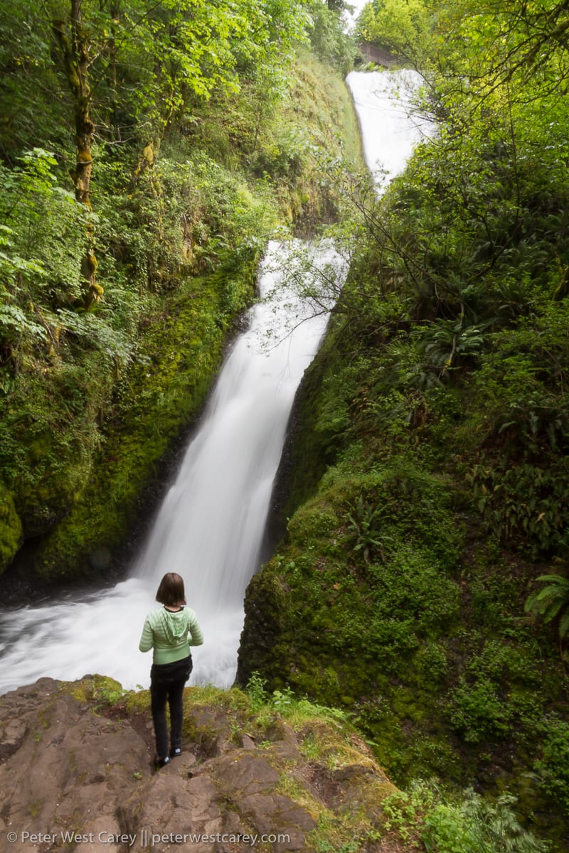 Girl standing near waterfall – USA – Oregon